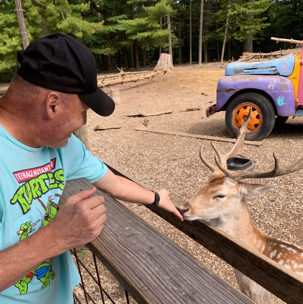 Man feeding a deer.