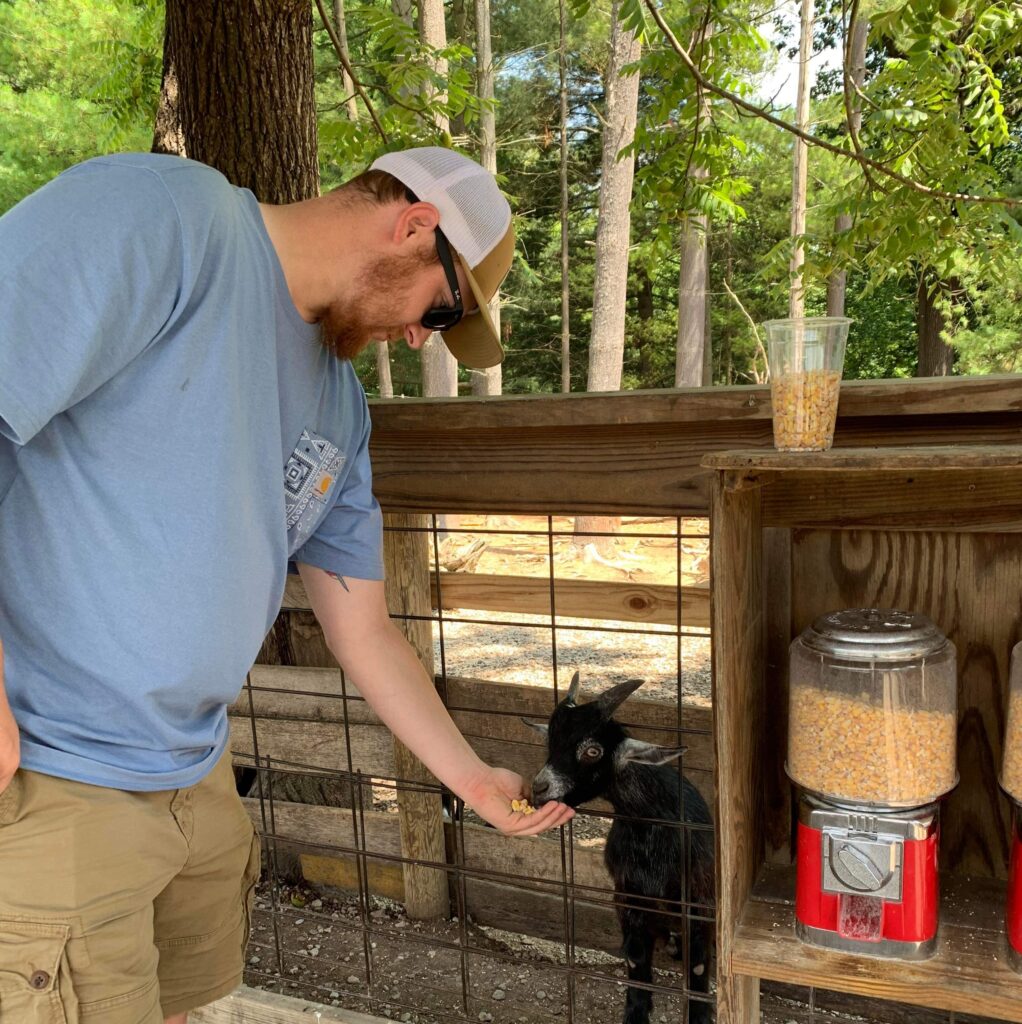 Man feeding a goat.